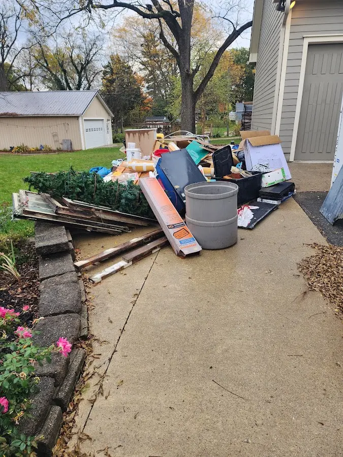 Dumpster being loaded with debris for Estate Cleanout Dumpster Rental in Hardeeville